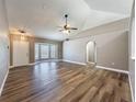 Spacious open living room with vaulted ceilings, arched doorway, and wood-look floors at 10124 Heathcliff St, Spring Hill, FL 34608