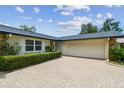 Charming home featuring a brick driveway leading to an attached two car garage at 1071 Lexington Ct, Largo, FL 33771