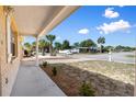 Inviting covered front porch with manicured landscaping, enhancing curb appeal and outdoor living at 11524 Meadow Dr, Port Richey, FL 34668