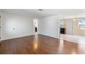 Spacious living room with wood flooring, bright lighting, and open layout at 11524 Meadow Dr, Port Richey, FL 34668