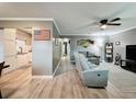 Spacious living room with wood floors, a ceiling fan, and comfortable seating, perfect for relaxing and entertaining at 11722 Carissa Ln # 49A, New Port Richey, FL 34654