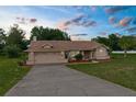 Charming single-story home featuring a well-manicured lawn and attached two-car garage at 13125 Jessica Dr, Spring Hill, FL 34609