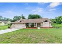 Attractive single-story home boasts a well-maintained lawn and a convenient two-car garage at 13125 Jessica Dr, Spring Hill, FL 34609
