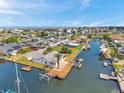 Waterfront home featuring a private dock, boat lift, and canal access, set amidst a picturesque neighborhood at 13836 Darlene Ave, Hudson, FL 34667