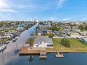 Charming waterfront home with a private dock, boat lift, and lush greenery, offering direct access to the canal at 13836 Darlene Ave, Hudson, FL 34667
