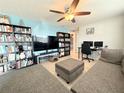 Comfortable living room with modern tile flooring, contemporary furniture, and a ceiling fan at 2141 Holiday Dr, Holiday, FL 34691