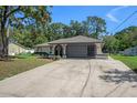 Charming single-story home featuring a large driveway and a two-car garage at 2152 Danforth Rd, Spring Hill, FL 34608