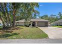 Charming single-story home with mature trees and a well-manicured lawn at 2152 Danforth Rd, Spring Hill, FL 34608
