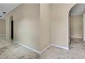 Spacious room with neutral walls and white ceramic tile flooring creating a bright and airy atmosphere at 2169 Danforth Rd, Spring Hill, FL 34608