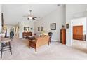 Bright and airy living room with high ceilings, neutral carpet, and elegant furnishings at 2209 Kings Palace Dr # 21-204, Riverview, FL 33578