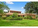 Well-maintained home with lush green lawn and mature trees offering shade and curb appeal at 23302 Lucerne Pl, Land O Lakes, FL 34639