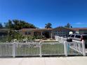 Charming single-story home with landscaped front yard and white picket fence at 3238 Coldwell Dr, Holiday, FL 34691