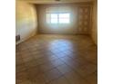 Empty living room featuring tile floors and a bright window at 3238 Coldwell Dr, Holiday, FL 34691
