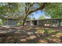 Charming single story home with brick and siding accents and shaded front yard at 34577 Orchid Pkwy, Dade City, FL 33523
