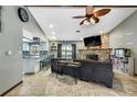 Spacious living room featuring tiled floors, stone fireplace, and an open floor plan at 364 Waterfall Dr, Spring Hill, FL 34608