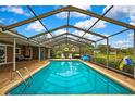 Private screened-in pool with an inviting outdoor living space and beautiful view at 364 Waterfall Dr, Spring Hill, FL 34608