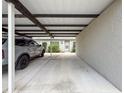 Attached carport providing covered parking, with condo entrance and landscaping at 3712 Trophy Blvd # 3712, New Port Richey, FL 34655