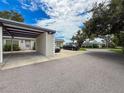 Exterior shot of condo with a carport, black cars parked, and a well-maintained lawn at 3712 Trophy Blvd # 3712, New Port Richey, FL 34655