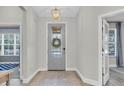 Bright entryway showcasing a decorative glass door and stylish foyer with neutral walls and modern lighting at 3885 Villamore Ln, Odessa, FL 33556