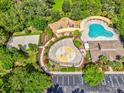 Aerial view of a community center featuring a pool, playground, splash pad and more at 4481 Birchfield Loop, Spring Hill, FL 34609