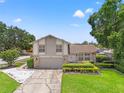 Charming two-story home with well-manicured lawn and a two-car garage on a sunny day at 5502 Bluejay Ln, Tampa, FL 33625