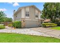 Two-story home boasts a two-car garage, stone accents, and a neatly maintained front yard at 5502 Bluejay Ln, Tampa, FL 33625