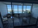 Relaxing lanai featuring comfortable seating with stunning water views from large picture windows at 5555 Gulf Blvd # 315, St Pete Beach, FL 33706