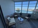 Cozy lanai offering a tranquil seating area and natural light with incredible views at 5555 Gulf Blvd # 315, St Pete Beach, FL 33706