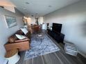 Stylish living room with hardwood floors, comfortable sofa, and modern entertainment center at 5555 Gulf Blvd # 315, St Pete Beach, FL 33706
