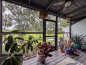 Relax on the screened porch with views of lush landscaping and plenty of room for potted plants at 7133 Trenton Pl, New Port Richey, FL 34653