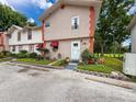 Attractive townhome with colorful awnings, manicured landscaping, and a welcoming entrance at 7135 Trenton Pl, New Port Richey, FL 34653