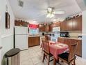 Functional kitchen with ample cabinetry, white appliances, and cozy dining area at 7135 Trenton Pl, New Port Richey, FL 34653