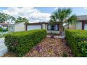 Inviting home boasts a well-manicured lawn, mature trees, and a private driveway leading to an attached garage at 7412 Bellows Falls Ln, Hudson, FL 34667