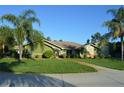 Attractive single-story home with lush green lawn and mature landscaping at 7550 Jomel Dr, Weeki Wachee, FL 34607