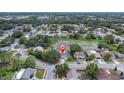 A charming home near a pond in a quiet neighborhood, showcased in an aerial view at 7701 Anaheim Ave, New Port Richey, FL 34655