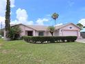 Charming single-story home features a well-manicured lawn, complemented by mature trees and shrubs for enhanced curb appeal at 9056 Horizon Dr, Spring Hill, FL 34608