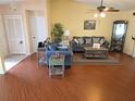 Inviting living room featuring wood floors, comfortable seating, and a relaxed atmosphere at 9056 Horizon Dr, Spring Hill, FL 34608