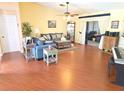 Bright living room features wood floors, vaulted ceiling and sliding doors leading to outdoor space at 9056 Horizon Dr, Spring Hill, FL 34608