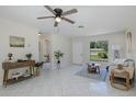 Bright living room with tile flooring, ceiling fan, and a view to the front yard at 9195 Bay Dr, Spring Hill, FL 34608