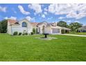 Well-maintained home exterior featuring lush lawn, landscape, and inviting curb appeal at 10285 Rosetti Ct, Spring Hill, FL 34608