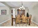 Formal dining room with decorative lighting and classic wood furnishings, perfect for gatherings at 11101 Ragsdale Ct, New Port Richey, FL 34654