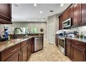 Well-equipped kitchen featuring stainless steel appliances, dark wood cabinetry, and ample counter space at 11101 Ragsdale Ct, New Port Richey, FL 34654