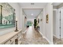 Inviting entryway featuring tiled flooring, artful decorations, and views into the living room at 11876 Ranchers Gap Dr, Odessa, FL 33556