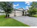 Charming single-Gathering home featuring a three-car driveway and stone accents on the facade at 11876 Ranchers Gap Dr, Odessa, FL 33556