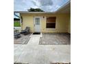 Cozy front porch with brick pavers, offering a charming entrance to the home at 12104 Boynton Ln, New Port Richey, FL 34654