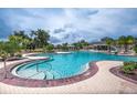 Enjoy a large community pool and spa surrounded by lush landscaping, perfect for relaxation and social gatherings at 13600 Crest Lake Dr, Hudson, FL 34669