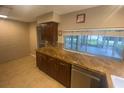 Spacious kitchen showcasing granite countertops, tile backsplash, stainless steel appliances and great backyard view at 1392 Piper Rd, Spring Hill, FL 34606