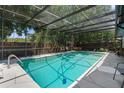 Enjoy the screened-in pool area, perfect for relaxing and entertaining guests year-round at 1430 Rosetree Ct, Clearwater, FL 33764