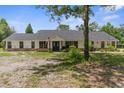 Well-kept single-story home featuring a neat lawn, traditional design, and a welcoming entrance at 14645 Spellman Ct, Spring Hill, FL 34610