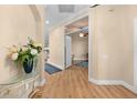 Welcoming foyer with wood floors, arched entryway, and views into adjacent rooms at 15004 Middle Fairway Dr, Spring Hill, FL 34609